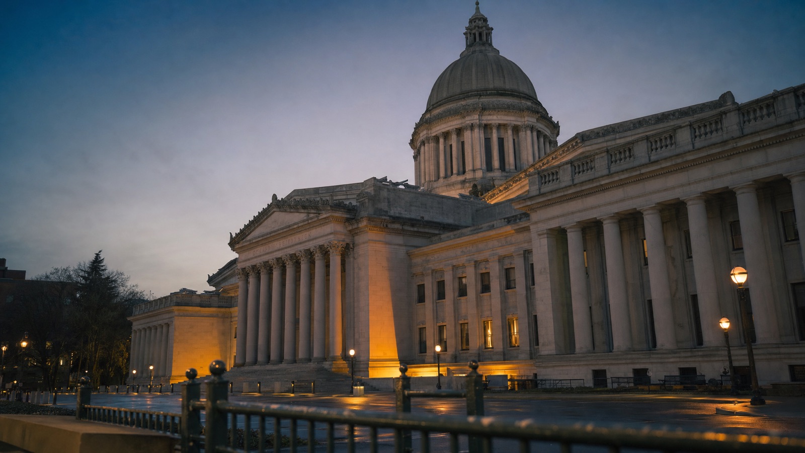 Neoclassical government parliament building at dusk, representing political tensions around the Starlink satellite internet contract